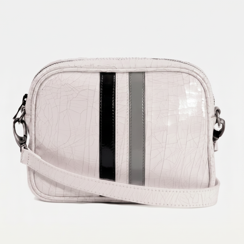 Light gray crossbody bag with black and gray striped accents on a white background