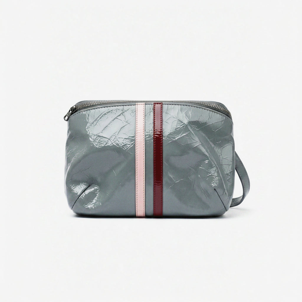 Gray crossbody bag with red and pink stripes on a white background