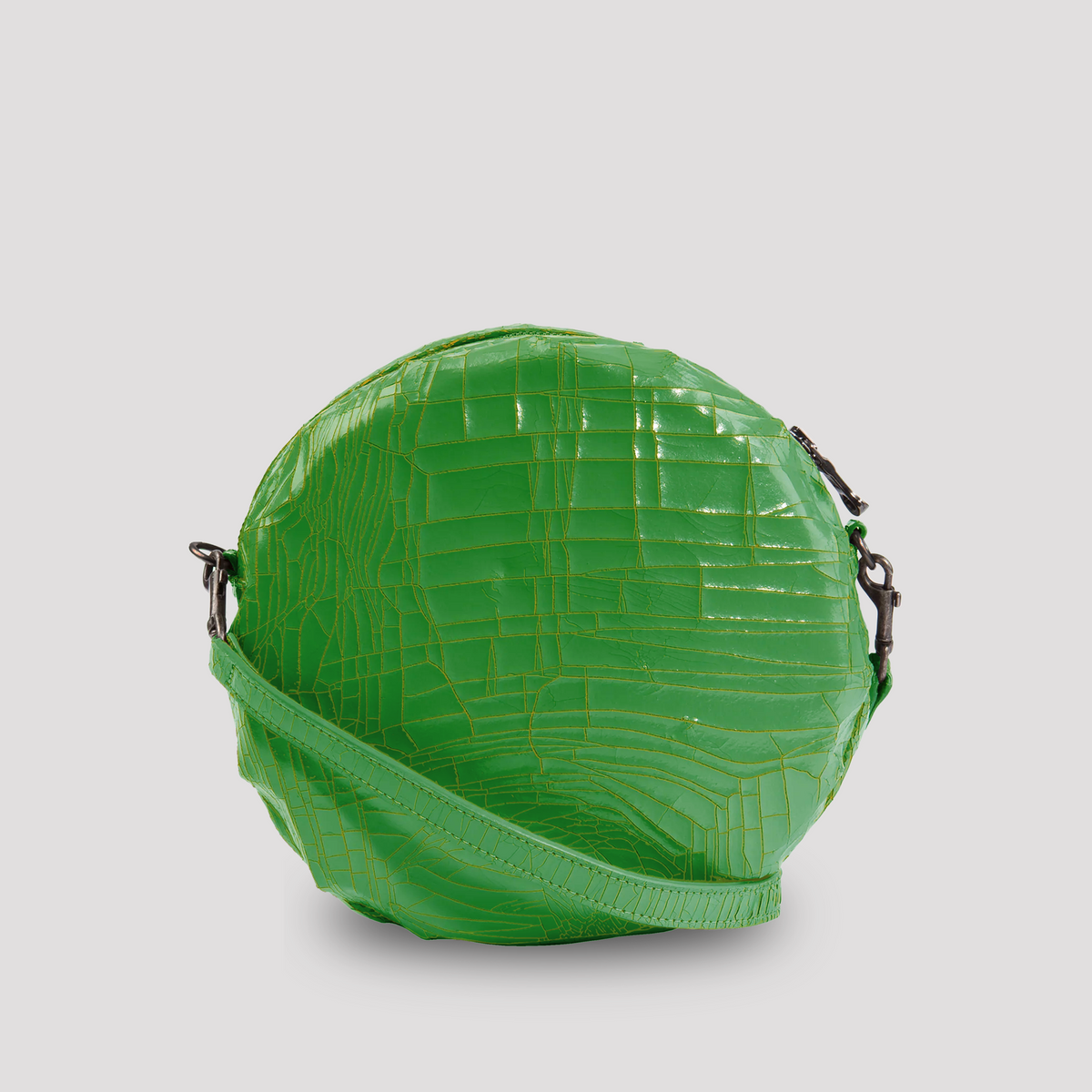 Green baby macaron from Marc Marmel featuring a smooth, pastel-colored shell and a sweet, delicate filling.