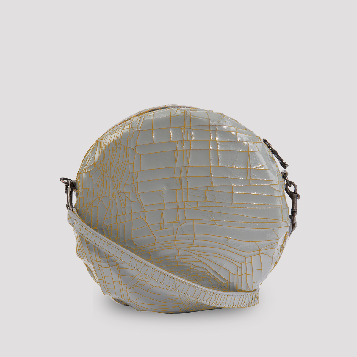 Gray baby macaron from Marc Marmel featuring a smooth, rounded appearance and delicate pastel-colored filling.