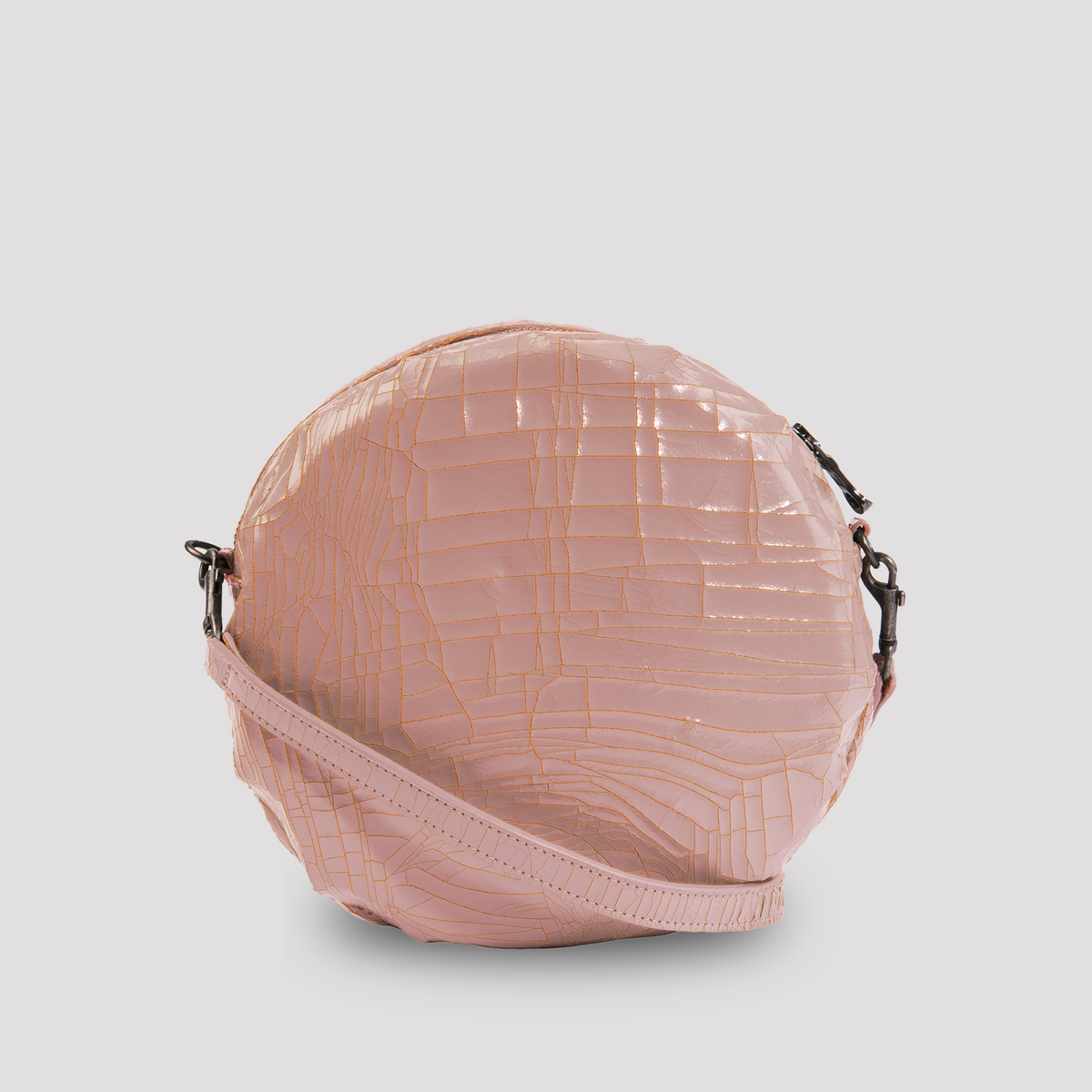 Pink baby macaron from Marc Marmel, soft pastel-colored French pastry with smooth, delicate texture and charming presentation.
