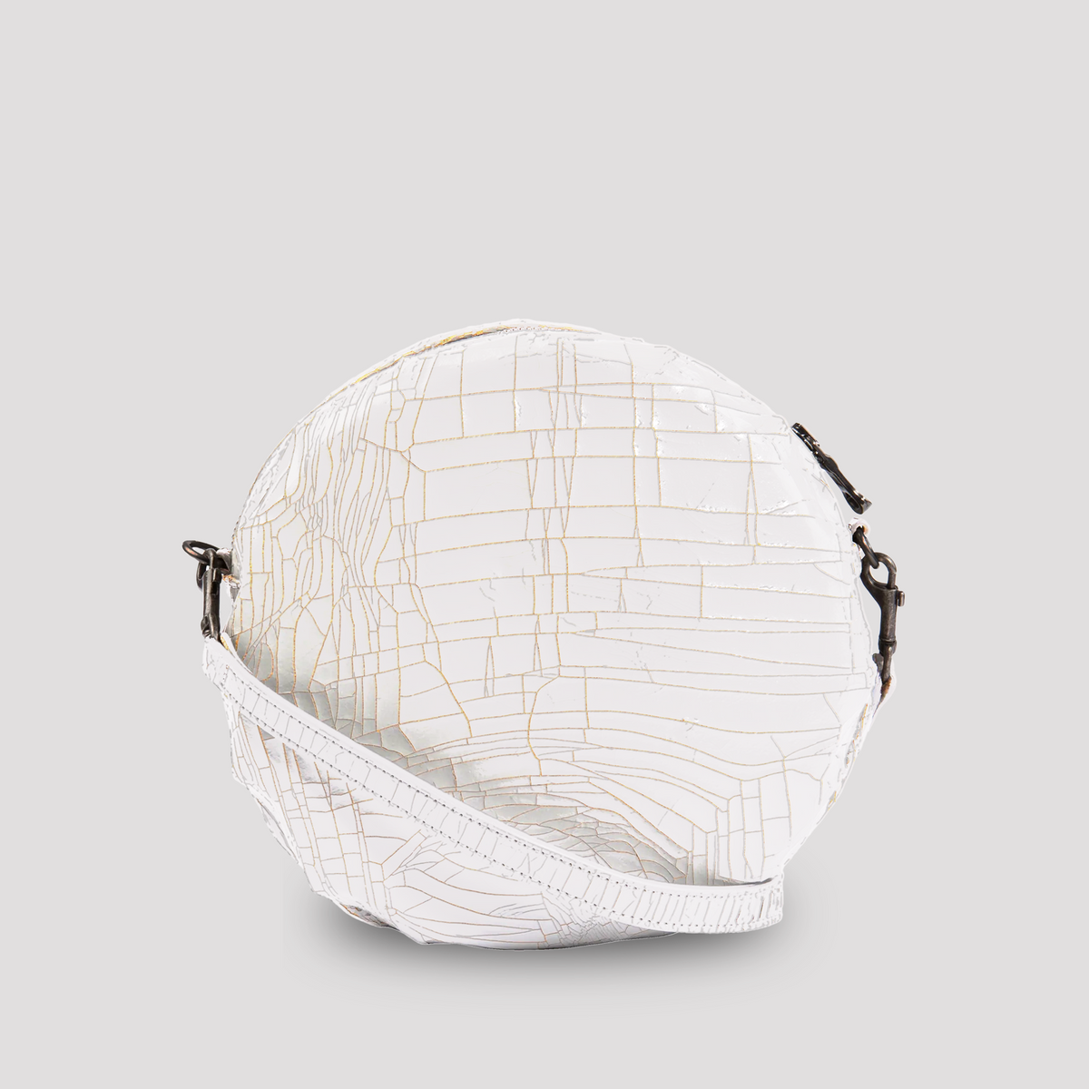 White baby macaron pastry from Marc Marmel, showcasing a delicate, smooth-textured dessert with a light, airy appearance.